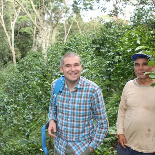 Joop Verbeek of IncaFé with coffee farmer in Peru, organic coffee trees and shade canopy